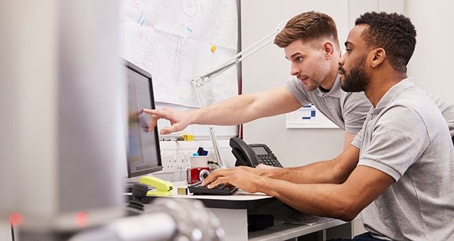 two men working at a computer