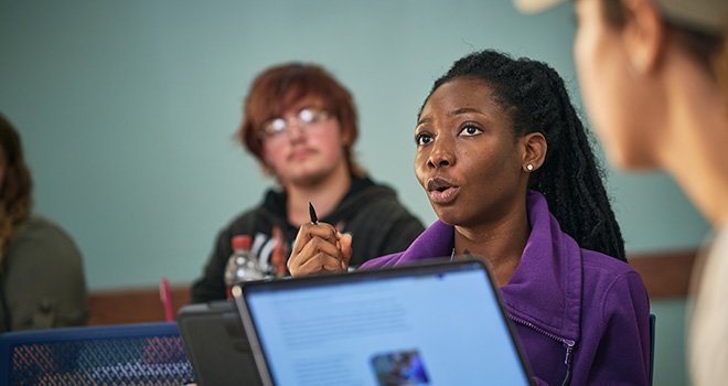 Female TCC student participates in discussion during class.