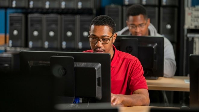 Two students using desktop computers