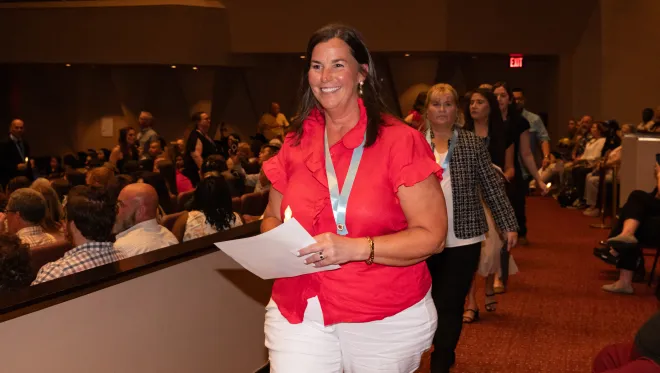 Robin Faulkner walks at the nurse pinning ceremony