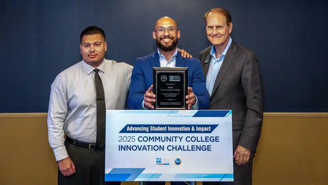 Adrian Carrillo, Jonathan Ford, and Jeff Horvath stand with an award plaque