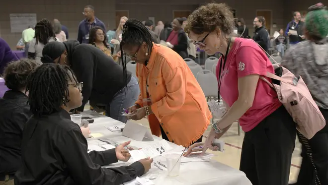 A reentry participant speaks with a volunteer