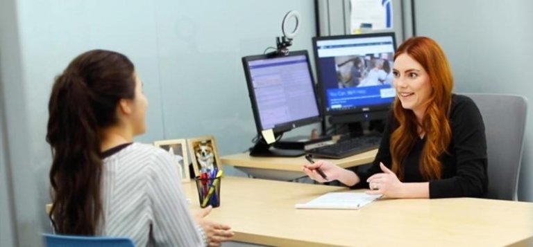 A TCC Academic Advisor speaks with a student in their office.