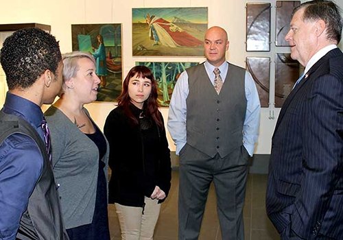 TCC TRIO students visit with a congressman at an art gallery.