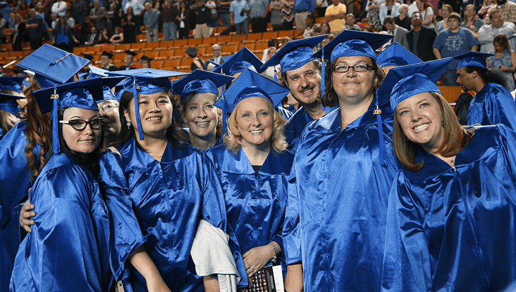 A group of TCC Graduates from 2015 Spring graduation pose for a group photo.