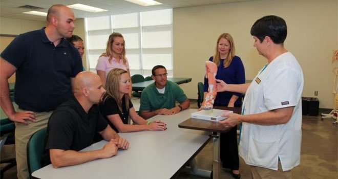 TCC professor Physical therapist talking to physical therapist students in class