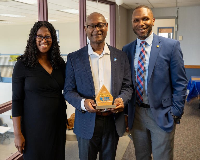 Eunice Tarver, Dewayne Dickens, and Keidron Dotson smile for a photo. Dickens is holding an award.